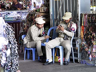 'Armed Security Staff at Phsar Thmei, Phnom Penh' by Asienreisender