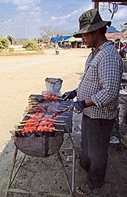 'A Khmer, Grilling Chicken at the Roadside' by Asienreisender