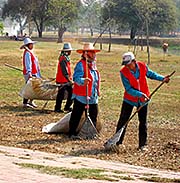 'Cleaning Staff at Work in Ayutthaya Historical Park' by Asienreisender
