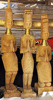 'Wooden Carvings of Kayan Women with Brass Necklace Coils in Ban Nai Soi' by Asienreisender