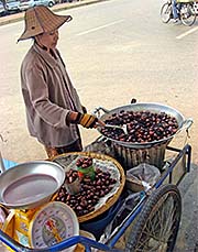 'A Chestnut Saleswoman at the Main Road in Mae Sai' by Asienreisender
